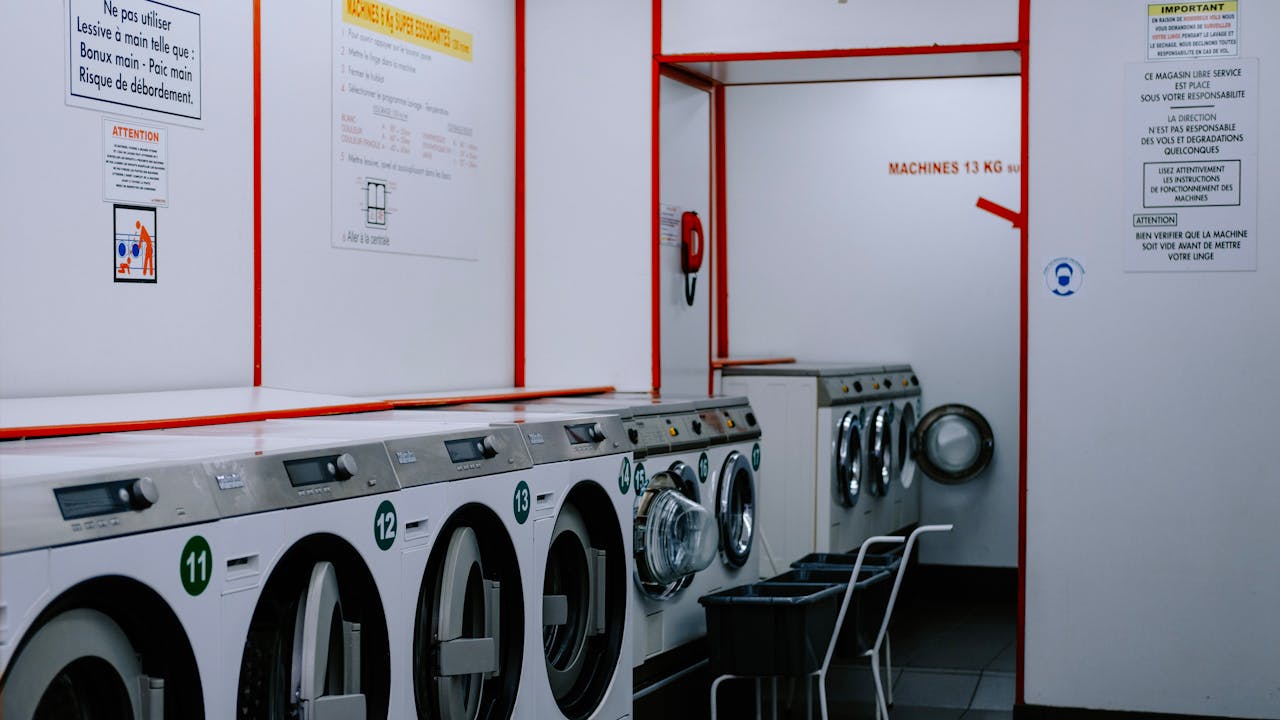 gallery-6 Inside a laundromat with washing machines lined up against the wall.